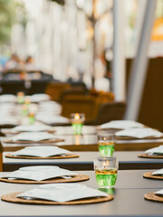 Table setting with candles and woven placemats in a restaurant