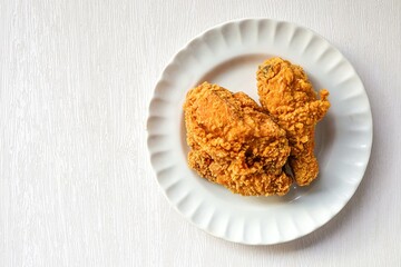Fried chicken in a white plate  on white background
