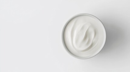 A delicious serving of yogurt with a spoon, possibly as breakfast or dessert. The yogurt is white and creamy in texture, suggesting it's fresh and nutritious.