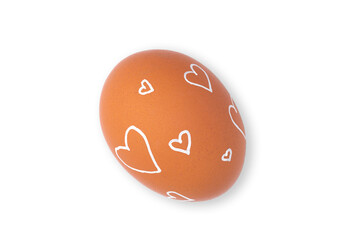 One Easter egg is a natural brown color with a minimalistic white pattern in the form of hearts isolated on a white background.