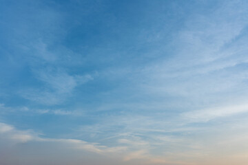 Fluffy white clouds drift across a vibrant blue summer sky