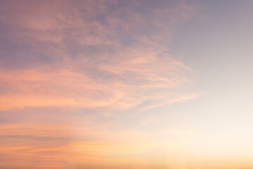 The vibrant hues of orange, red, and yellow paint the sky as the sun dips below the horizon, casting a magical glow on the clouds in this breathtaking sunset landscape