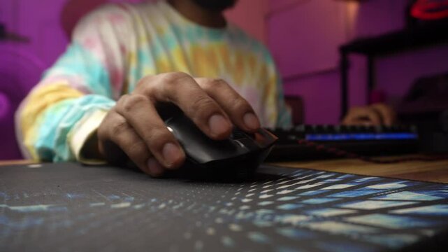 Gamer intently clicking mouse on a colorful mousepad