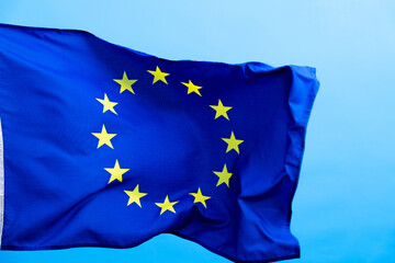 European Union Flag waving on blue background