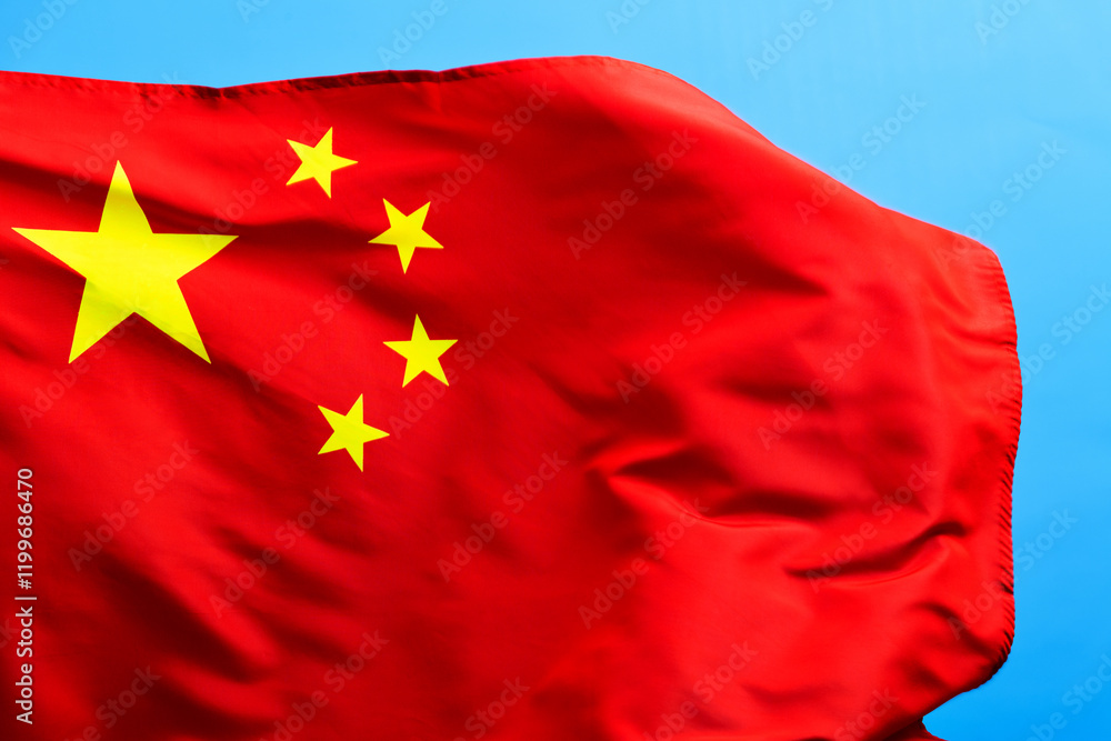 Wall mural Chinese flag waving on blue background