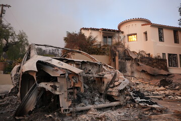 Car sitting in front of a surviving home in the palisades wild fire