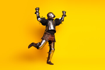 Armored Individual Posing Against Bold Yellow Background Symbolizing Historical Charm