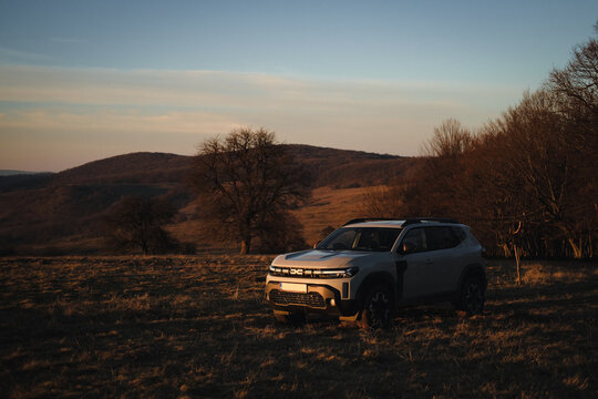 SASCHIZ, ROMANIA - DECEMBER 30, 2024: New Dacia Duster 4x4 sport urban vehicle on offroad hill at sunset.