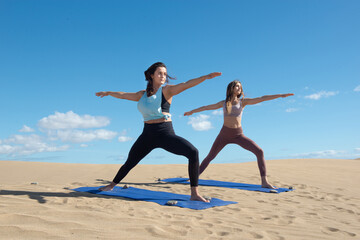 Obraz premium women in yoga or streching practisse at the beach