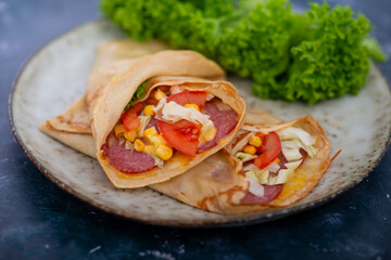 pancakes with meat and salami, corn and cabbage