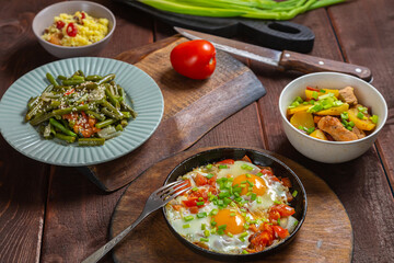 Set table, Jewish food, tzimmes, chelnt, shakshuka and couscous with dried fruits