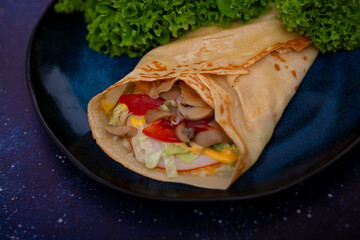 A savory pancake filled with ham and melted cheese offers a delightful combination of flavors. The pancake's golden, crispy exterior encases a warm, savory filling for a satisfying, hearty meal.