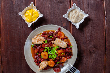 beans stewed with meat and dried fruits and sauce and hummus