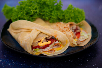 A savory pancake filled with ham and melted cheese offers a delightful combination of flavors. The pancake's golden, crispy exterior encases a warm, savory filling for a satisfying, hearty meal.