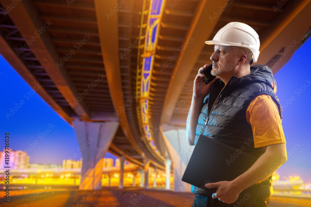 Aufkleber man builder stands under bridge. road architect talking on phone. man inspector checks quality of co