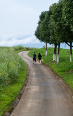 Obraz premium Mother and son walking on country road