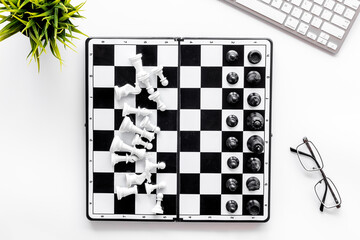 Challenge and leadership concept. Chess board on office table, top view
