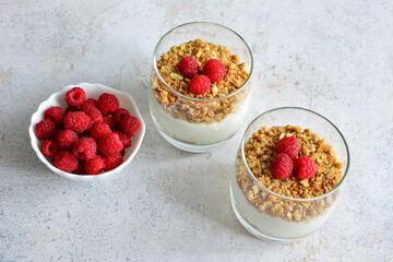 Granola Parfait with Raspberries on the gray table top view 