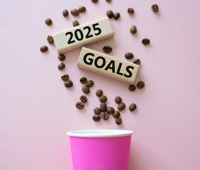 2025 Goals symbol. Concept word 2025 Goals on wooden blocks. Beautiful pink background with coffee cup. Business and 2025 Goals concept. Copy space.