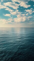 Obraz premium View of a calm sea from the deck of a ship in the middle of the ocean. Convey the serenity of the open sea with a peaceful atmosphere, capturing the expansiveness of the calm waters under a vast sky, 