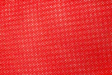 a close-up of a red fabric featuring a fine textured pattern.
