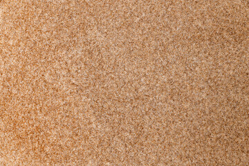 Close-up of coarse tan fabric with visible fibers, rough texture