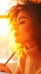 Fototapeta premium Young Black woman with curly hair sits in warm sunlight, pensively writing in a notebook.