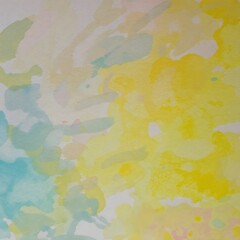 Abstract watercolor wash yellow and teal blend softly on textured paper