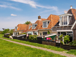 Dyke and backyards of historic houses in old town of Makkum, Friesland, Netherlands