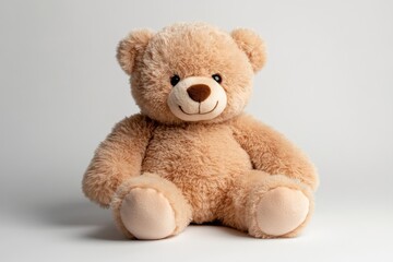Obraz premium Soft teddy bear sitting on a light background capturing the essence of childhood comfort and innocence