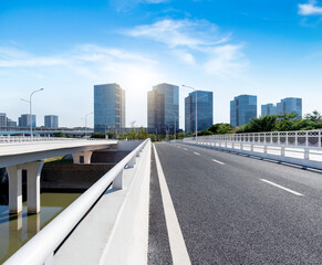 Asphalt road bridge near office buildings