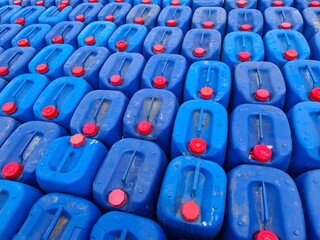 Fototapeta premium Background image of blue oil drums used to refuel fishermen's boats at sea.