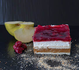 A Tres Leches cake (Tri leće) from a bakery, photographed on a black background. The cake features...