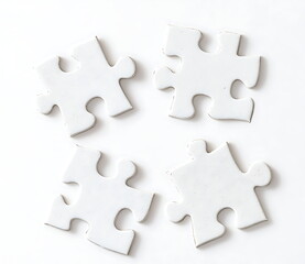 Obraz premium white puzzle pieces on the table on white background