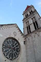 Bell tower of the Cathedral of St. Lawrence against the blue sky on a sunny summer day, Trogir,...