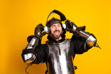Young armored knight enjoying music against a vibrant yellow backdrop