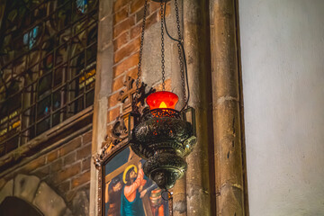 red lantern in the church. church light and lighting on the background of a religious painting with Jesus