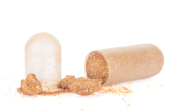 Expired and Hardened Capsule with Spilled Powder on White Background