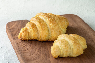 Two croissants on a wooden table