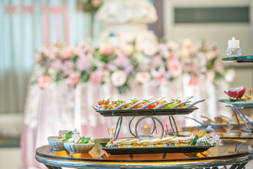 A table full of food with a pink and white decorated background