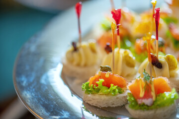 A silver platter of hors d'oeuvres with toothpicks