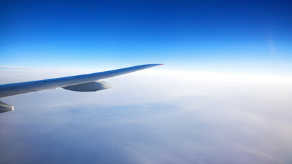 Fototapeta premium View of airplane wings and sky from airplane window