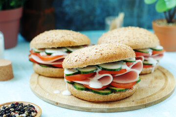 Bun sandwiches with salami and vegetables