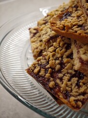 Deliciously baked dessert bars topped with crumble and filled with sweet jam, perfect for afternoon...