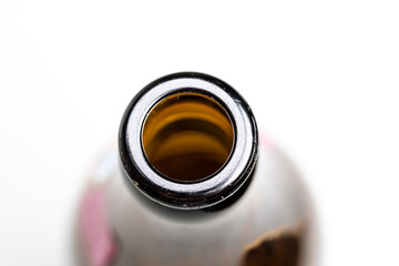 A bottle of beer with a brown cap and a brown neck
