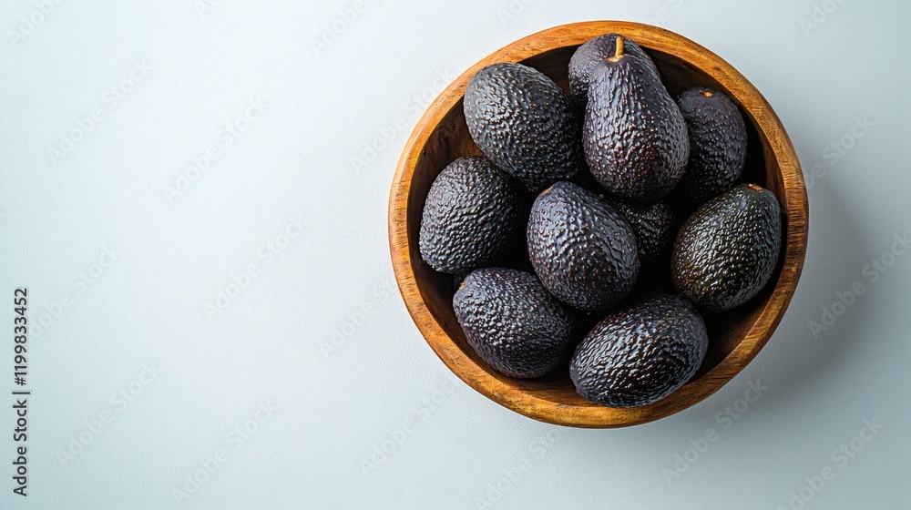 Poster isolated of an assortment of avocados with varying sizes and shapes displayed in a wooden bowl again