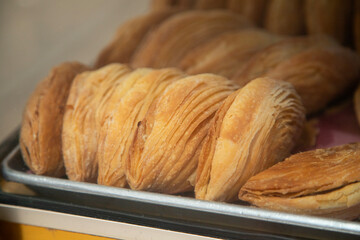 Traditional sweets stand with empanadas, cocadas, mamones in the Oaxaca food market.