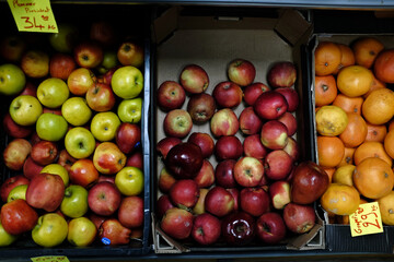 apples and oranges in a boxes in a market