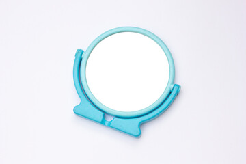 Blue framed round table mirror isolated on white background