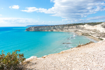 Fototapeta premium View of Zapallo Bay Beach in Cyprus: Azure Sea and Rocky Cliff on a Sunny Day